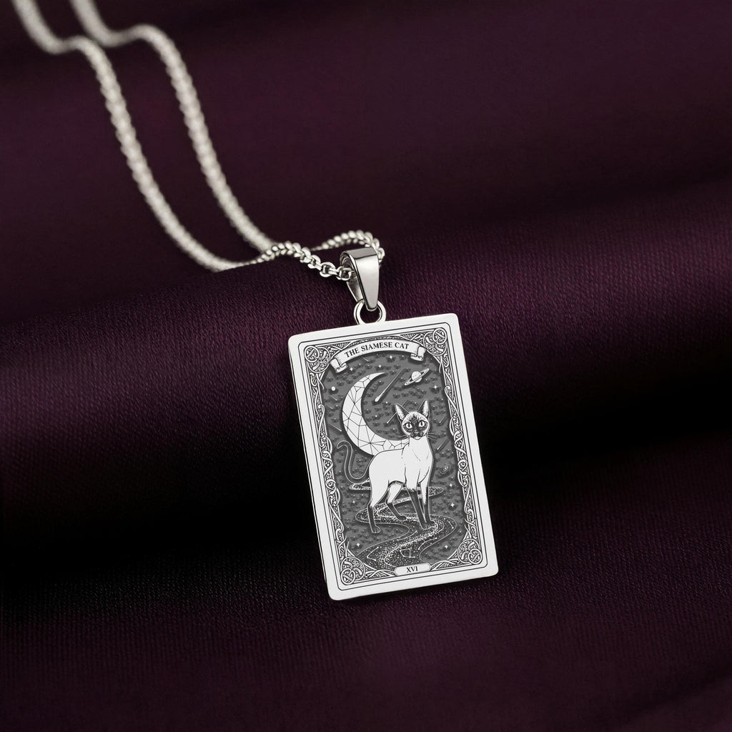 A striking 925 sterling silver Siamese Cat charm. The art shows the serene cat, a meaningful piece of witchy jewelry for her.