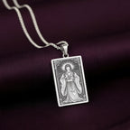 A handcrafted 925 sterling silver Amaterasu charm in a rectangular tarot card shape. This personalized piece of Japan culture jewelry shows the goddess as described in the ancient Kojiki texts.