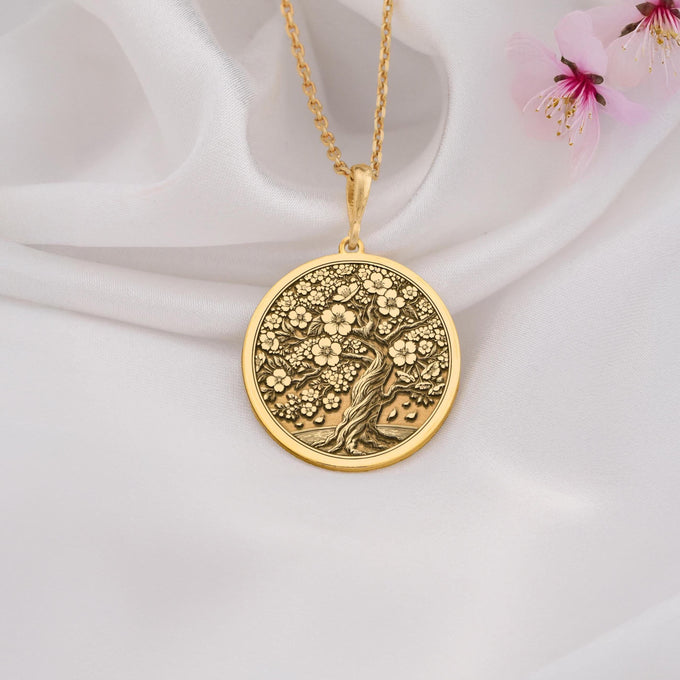 14K Gold Sakura Tree Pendant featuring a cherry blossom design, symbolizing renewal and beauty. Perfect for nature lovers and gift giving occasions.