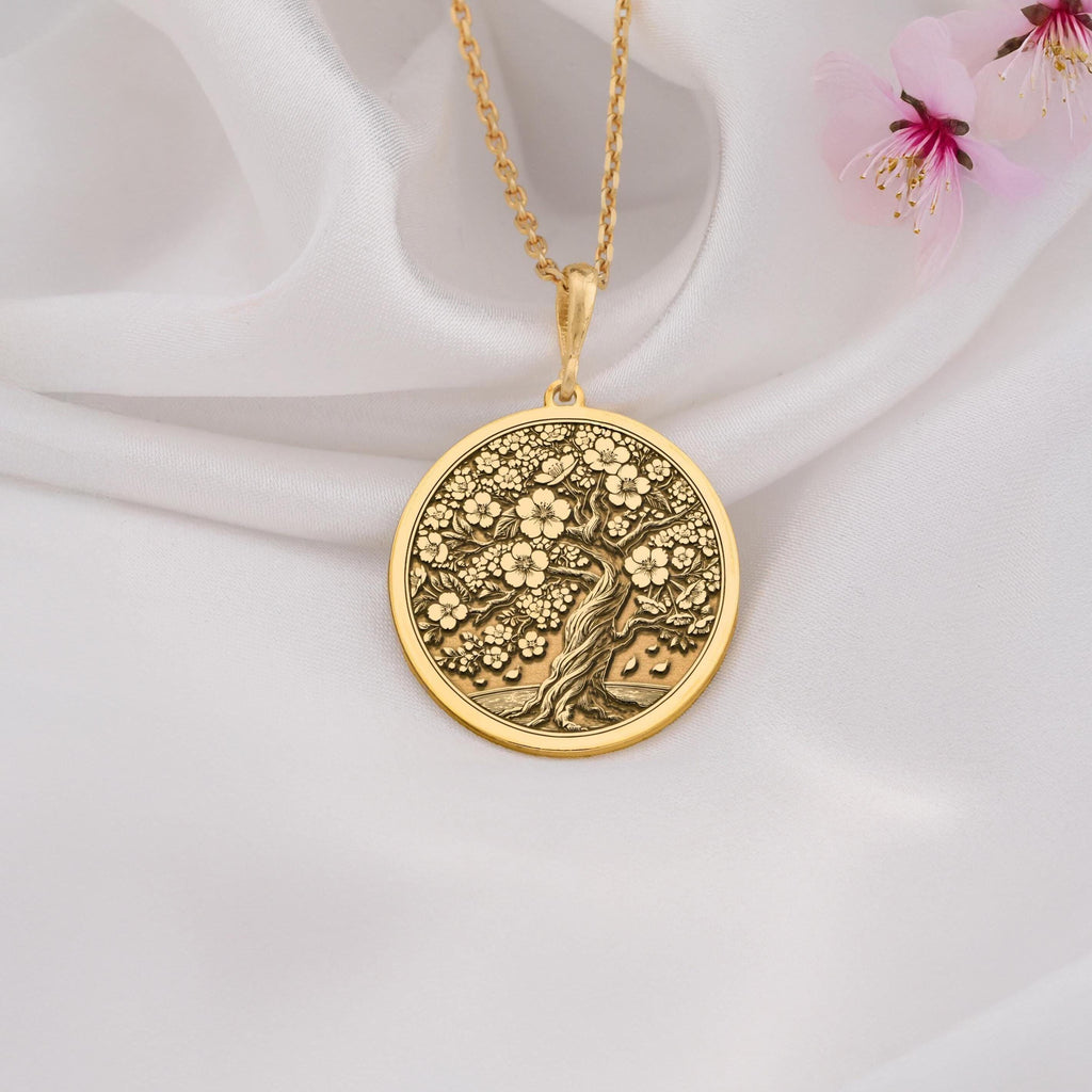 14K Gold Sakura Tree Pendant featuring a cherry blossom design, symbolizing renewal and beauty. Perfect for nature lovers and gift giving occasions.