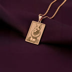 A chic rose gold plated necklace with a rectangular pendant, featuring a unique engraved portrait of a Sphynx cat in a ruff collar.