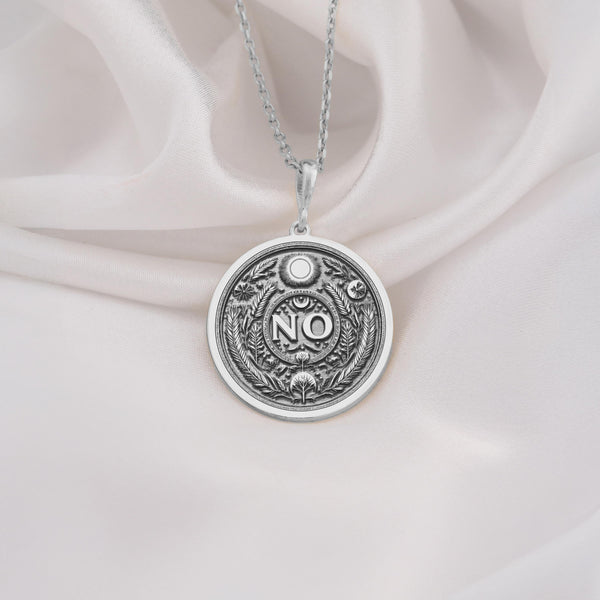 925 Sterling Silver NO Medallion showcasing powerful boundary word with protective symbols. Detailed self-advocacy coin pendant with evil eye, moon and botanical elements. Premium empowerment jewelry symbolizing personal limits and self-respect.
