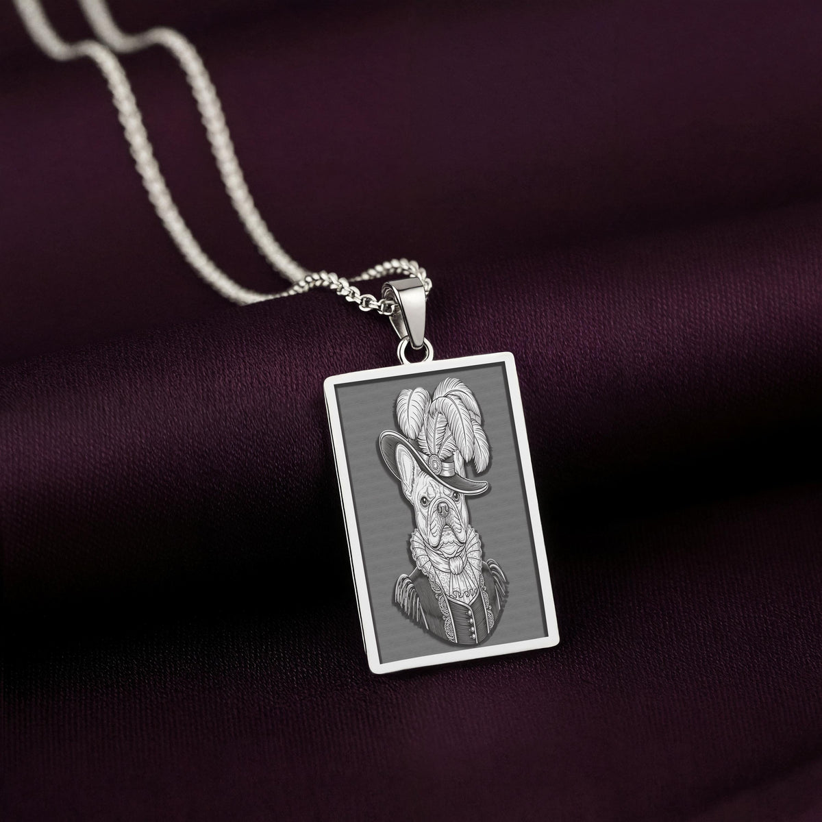 Angled view of the 925 Sterling Silver French Bulldog necklace. The polished metal gleams, highlighting the dimensional quality of the Renaissance-inspired engraving.