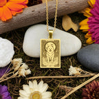 A handmade 14K gold plated Samoyed necklace. The engraving captures the angelic dog in a celestial "Moon" tarot card style.