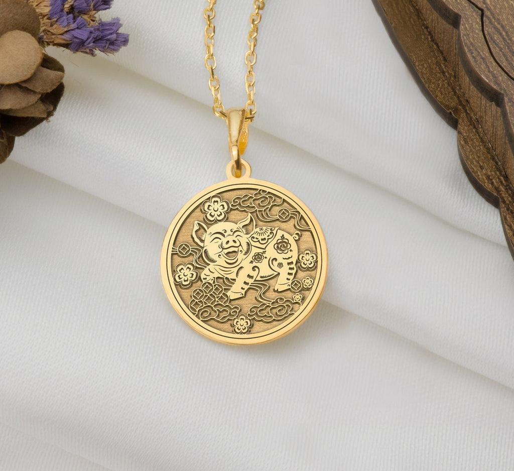 Front view of Pig Zodiac Animal Charm Pendant in 14K solid gold, featuring an engraved smiling pig with clouds and floral details.