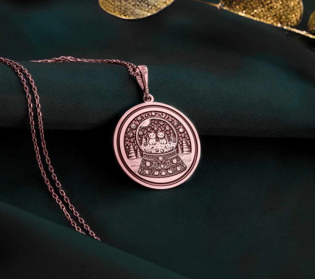 Rose gold plated snow globe pendant featuring two cats in a whimsical coin-style medallion. Handmade and elegant, perfect gift for cat lovers and special occasions.