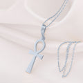 Ankh Key of Life Pendant in sterling silver on a fine chain, displayed against white fabric.