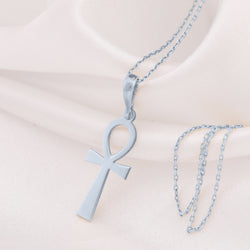 Ankh Key of Life Pendant in sterling silver on a fine chain, displayed against white fabric.