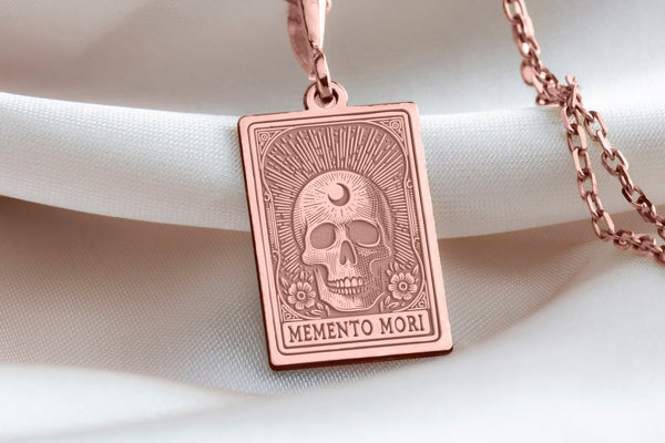 Rose gold-plated Memento Mori skull pendant, dainty charm necklace, minimalist and boho-inspired, layering jewelry, unique resilience symbol, lightweight for everyday wear, handcrafted, perfect gift for her.