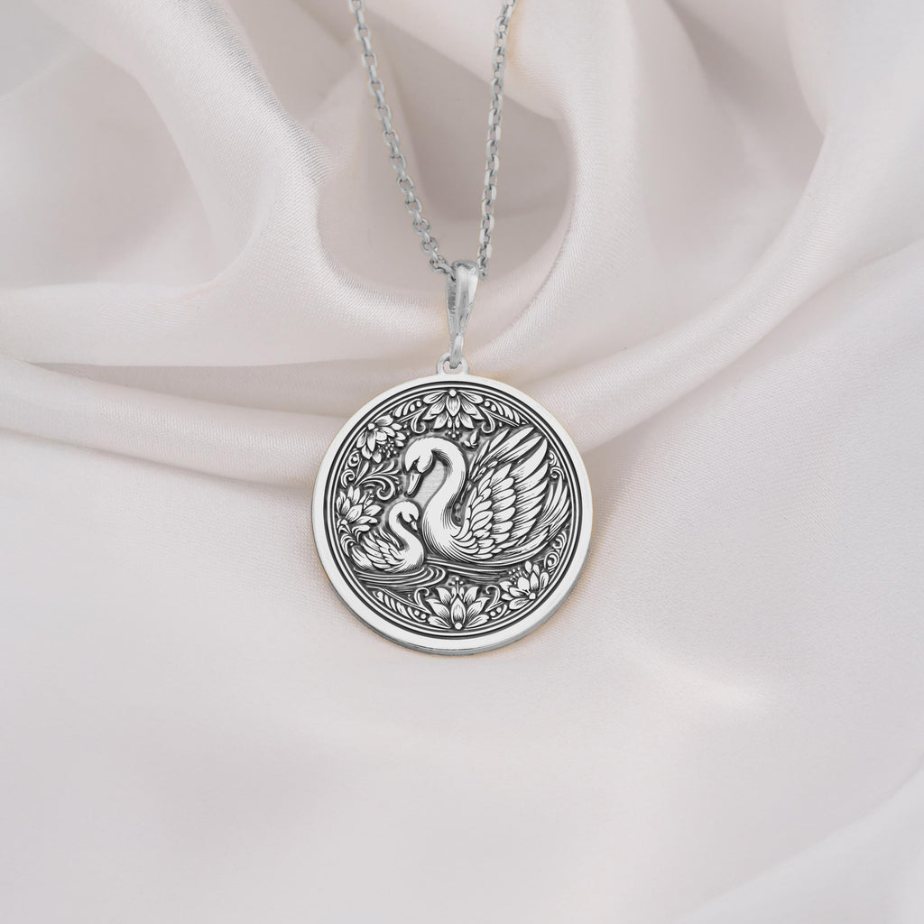 925 Sterling Silver Mother Baby Swan Medallion showcasing protective mother swan with baby cygnet surrounded by ornate elements. Detailed family coin pendant with maternal design. Premium swan jewelry symbolizing family bonds.