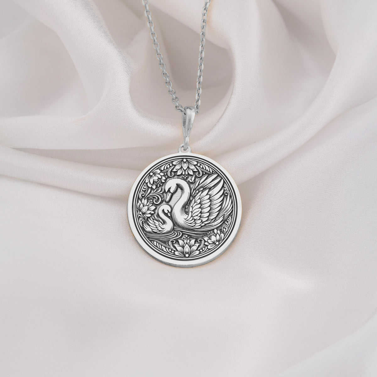 925 Sterling Silver Mother Baby Swan Medallion showcasing protective mother swan with baby cygnet surrounded by ornate elements. Detailed family coin pendant with maternal design. Premium swan jewelry symbolizing family bonds.