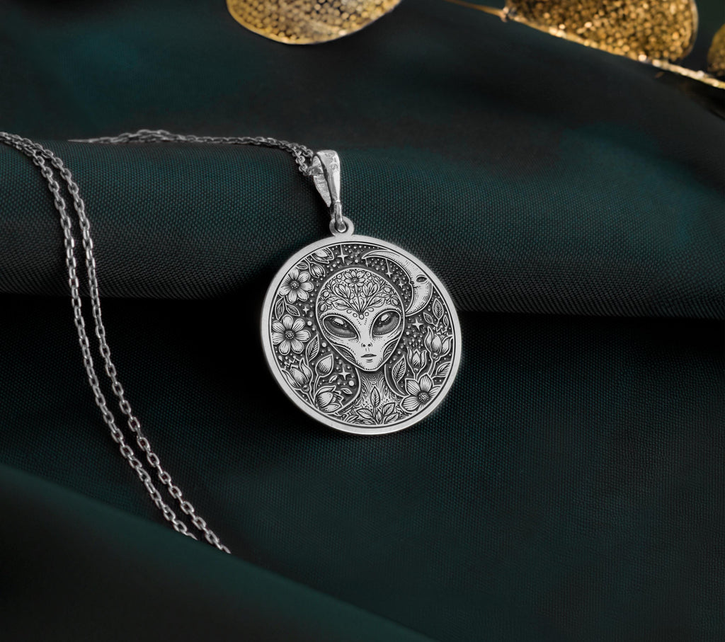 Sterling Silver extraterrestrial necklace, engraved with a detailed cosmic design, representing mysticism, space exploration, and universal wisdom. A unique sci-fi jewelry piece for those who love space.
