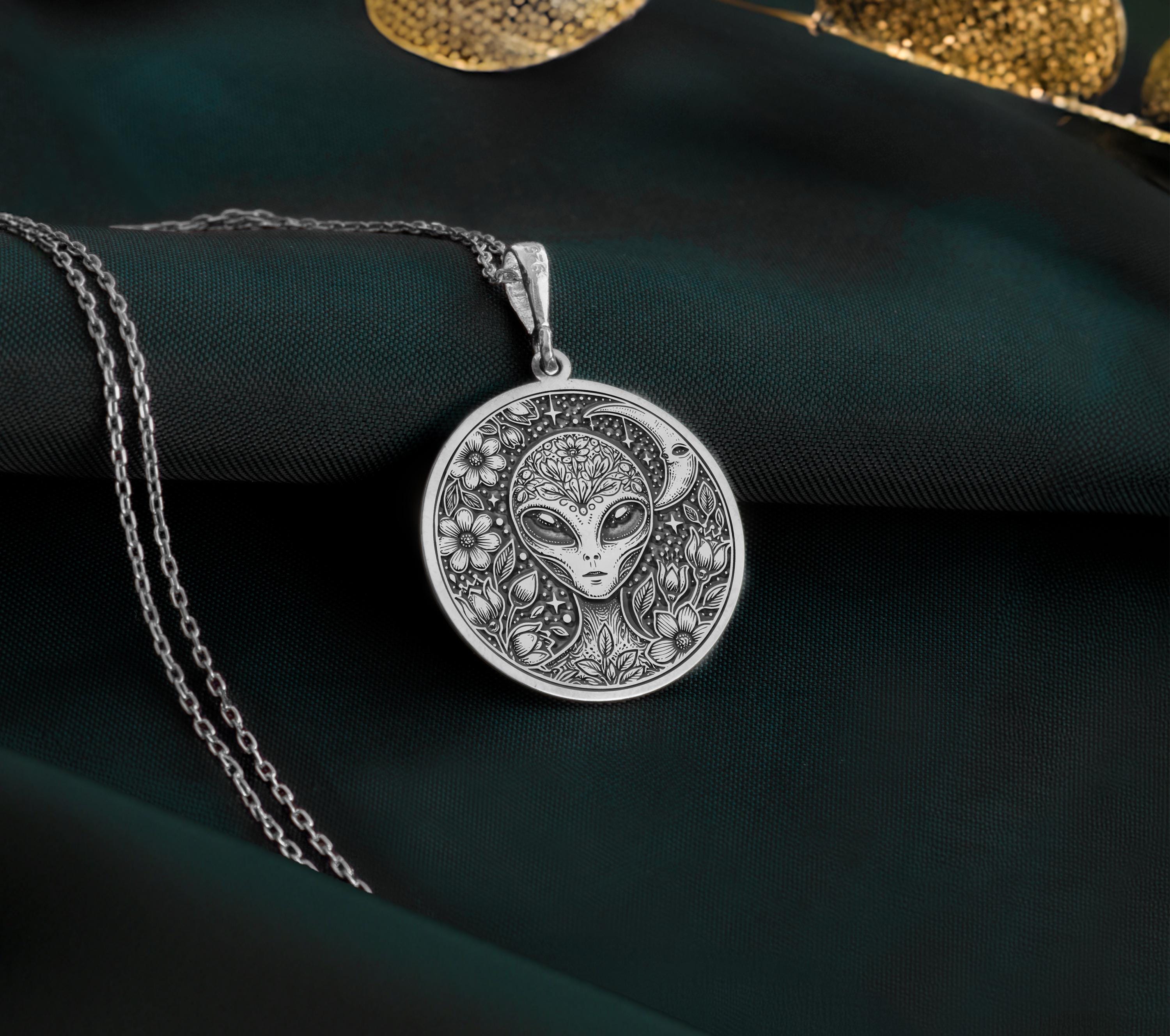 Sterling Silver extraterrestrial necklace, engraved with a detailed cosmic design, representing mysticism, space exploration, and universal wisdom. A unique sci-fi jewelry piece for those who love space.
