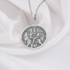 Sterling silver Durga pendant necklace showcasing the revered Hindu goddess seated on her tiger vahana. This detailed circular medallion captures Durga with multiple arms holding symbolic weapons and objects. The pendant features meticulous engravings with an oxidized finish to highlight the intricate details of the goddess and her tiger mount. Displayed on white silk fabric with a matching silver chain, this spiritual jewelry piece symbolizes feminine strength, protection against evil