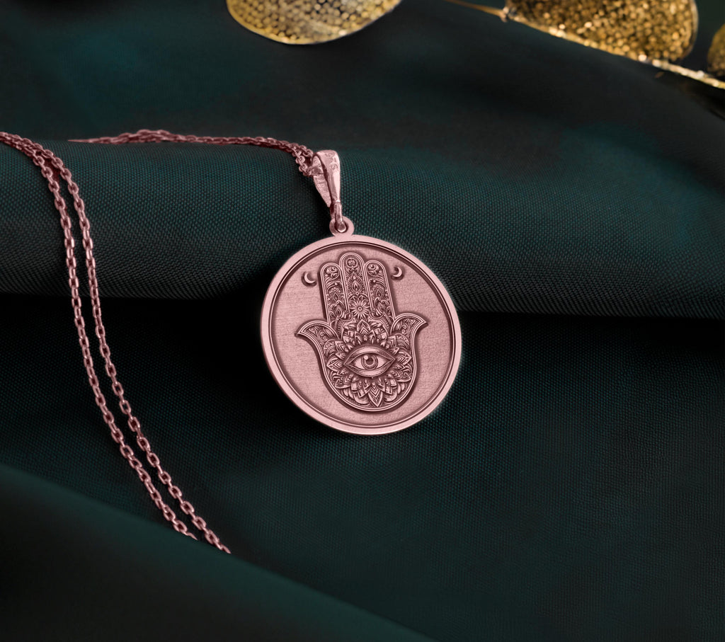 Rose Gold Plated Hamsa pendant with Evil Eye charm, a symbol of divine protection and harmony. Feminine and meaningful gift choice for birthdays, holidays, or spiritual milestones.