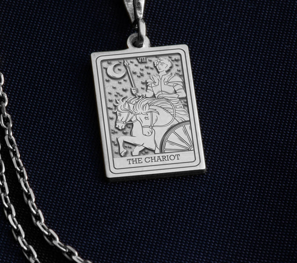 The Silver Chariot Necklace is a beautifully crafted piece made from 925K sterling silver, featuring a detailed tarot charm design. Perfect for tarot enthusiasts, spiritual seekers, or anyone looking for a unique gift, this necklace combines elegance and meaning. It comes with a spring ring clasp, ensuring durability and a luxurious finish. Embrace the energy of The Chariot tarot card with this meaningful jewelry piece, ideal for daily wear or special occasions.