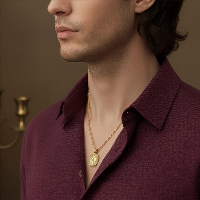 A man models the personalized 14k gold Ganesh Yantra necklace, a unisex spiritual amulet for success and new beginnings. The Elephant God pendant rests on his chest, showcasing its appeal as a masculine spiritual accessory. This powerful sacred geometry talisman is a meaningful gift for him, also available in 925 sterling silver and rose gold options.