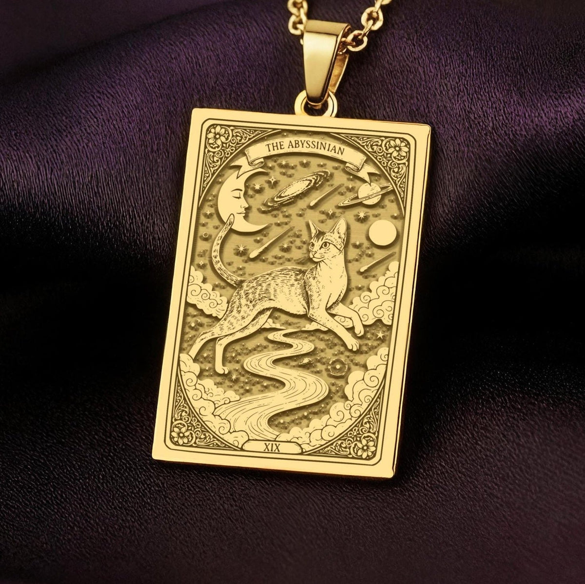An heirloom-quality 14K solid gold Abyssinian Cat tarot pendant. The art shows the sleek cat leaping, a precious gift for a cat lover.