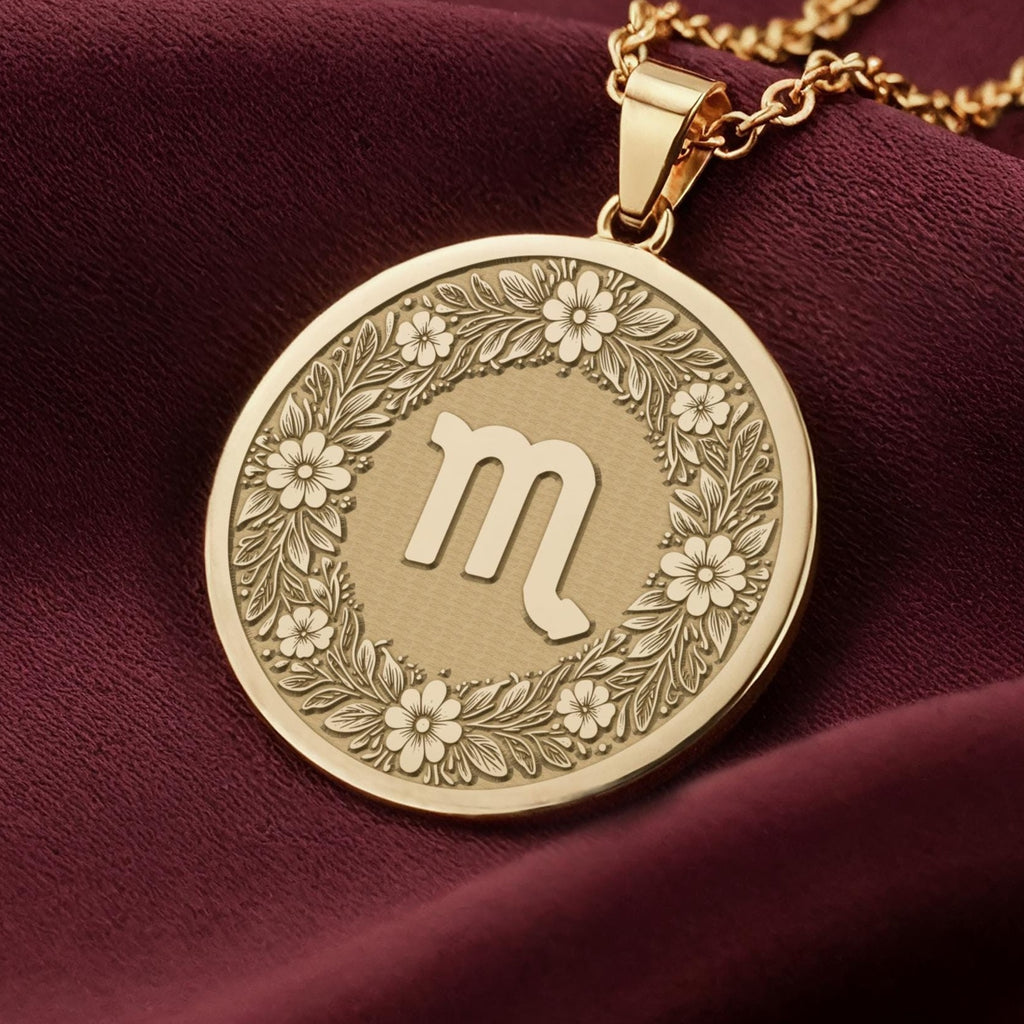 14K Solid Gold Scorpio Zodiac Medallion with Scorpio symbol (♏) and a floral wreath border. A perfect personalized gift with optional back engraving. Detailed celestial horoscope jewelry.