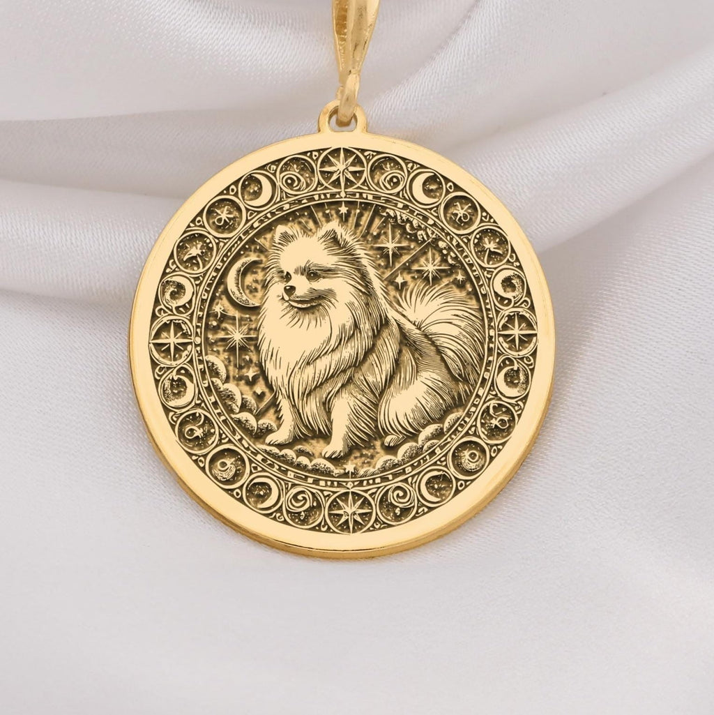 a gold necklace with a picture of a dog on it
