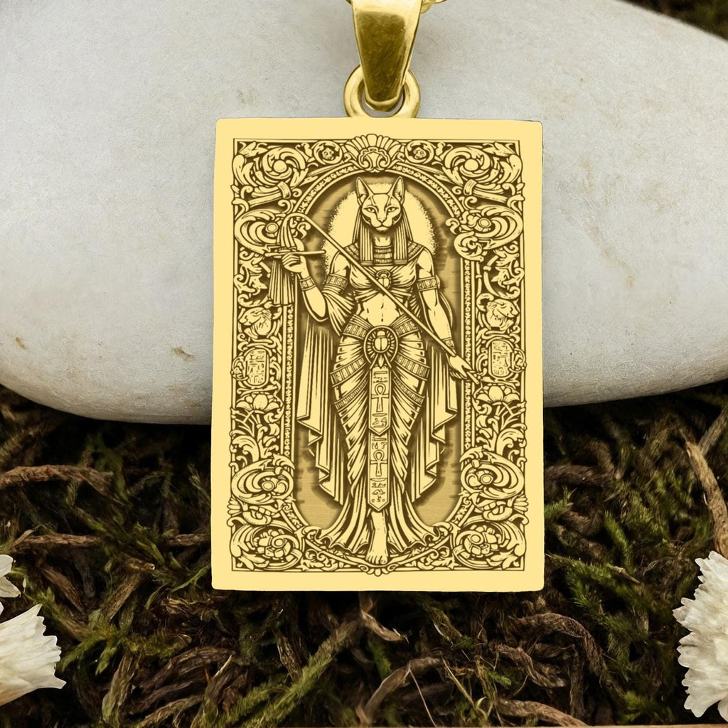 An heirloom-quality 14K solid gold tarot card amulet depicting the Goddess Bastet. This fine engraved jewelry is a sacred Kemetic paganism symbol.