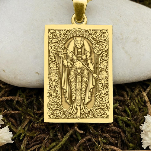 An heirloom-quality 14K solid gold tarot card amulet depicting the Goddess Bastet. This fine engraved jewelry is a sacred Kemetic paganism symbol.