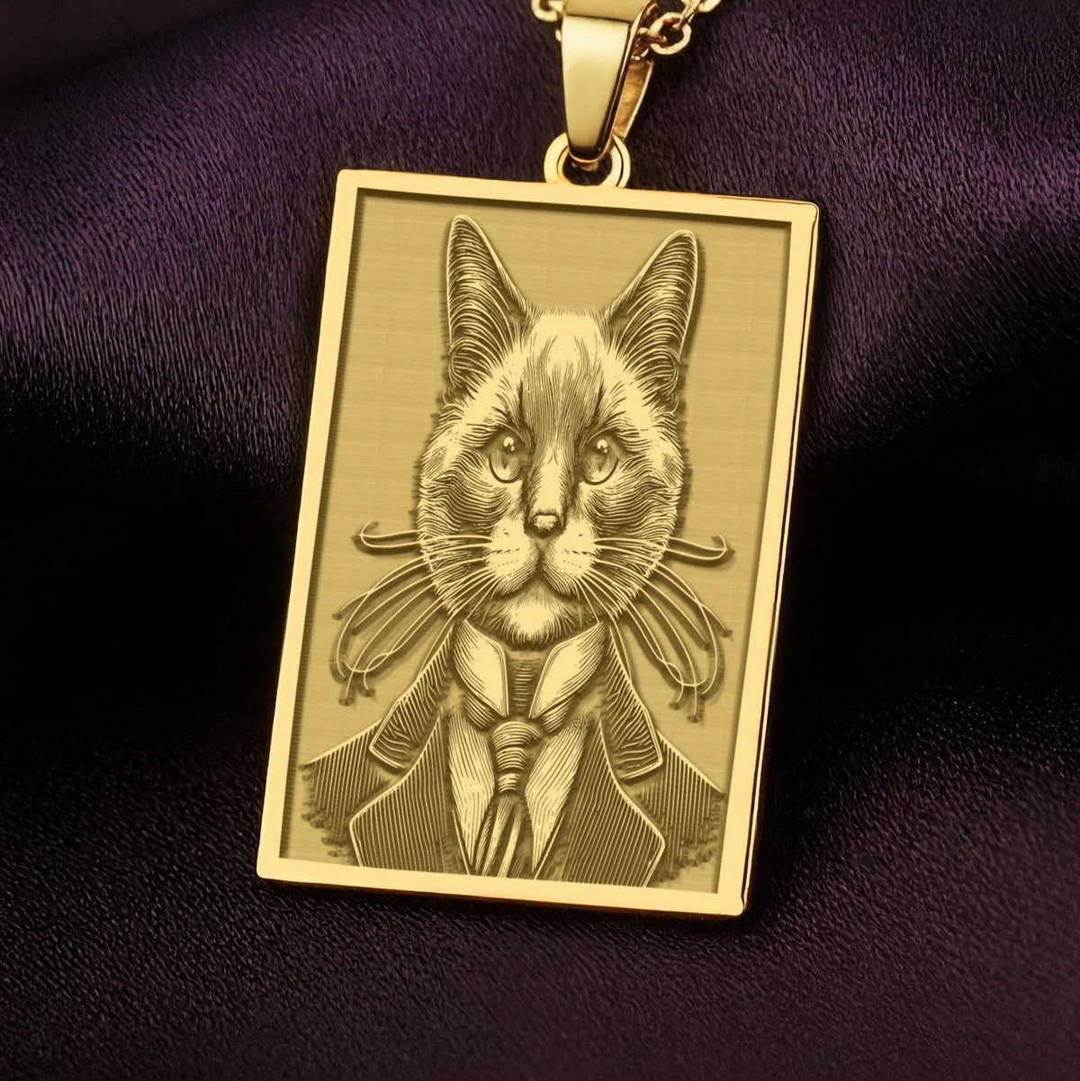 A rectangular 14K gold plated pendant necklace featuring a detailed laser engraving of a dapper Siamese cat in a Victorian suit.