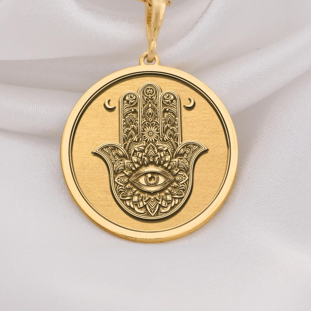 Hamsa Hand Protection Amulet Necklaces 14K 14K Gold Plated pendant necklace featuring a stylized eye motif with crescent shapes.