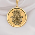 Hamsa Hand Protection Amulet Necklaces 14K 14K Gold Plated pendant necklace featuring a stylized eye motif with crescent shapes.