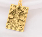 The Tower tarot card  boho chic pendant necklace , depicted in a striking gold color features a tall, imposing structure being struck by highlighting the crumbling tower as it tilts precariously. Two figures are shown falling from the structure, symbolizing sudden upheaval or chaos. The background is often minimal, allowing the vivid gold tones to emphasize the tower's destruction and the sense of unexpected change or revelation it represents.
