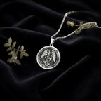 Archangel Michael Coin Pendant Pendants 925 925 Sterling Silver winged angel pendant necklace on black fabric.
