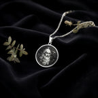 Da Vinci Renaissance Art Pendant Necklaces 925 925 Sterling Silver portrait pendant necklace with bearded man design on dark fabric.