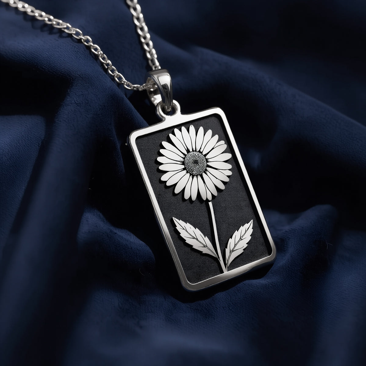 Silver pendant necklace featuring a daisy floral design with a smooth, polished surface finish. The image shows the pendant alone against a dark background.