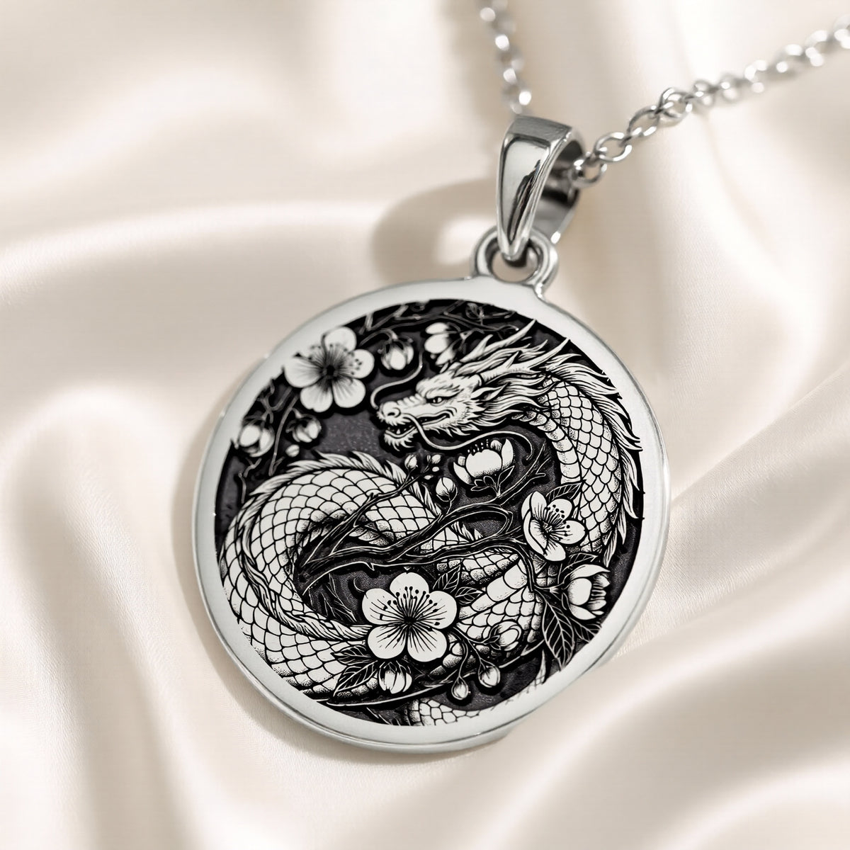 Silver pendant featuring an intricate Japanese dragon motif with a detailed surface finish, viewed from above on a velvet background