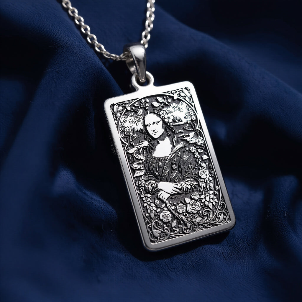 Silver pendant featuring a detailed outline of the Mona Lisa, antique style, with an intricate filigree design. The pendant has a textured surface finish and is suspended from a delicate chain.