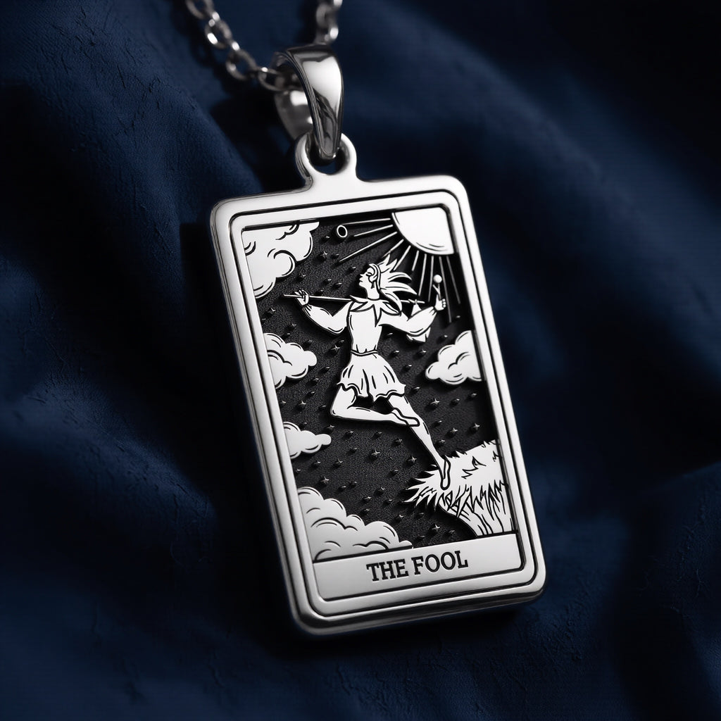 Rectangular oxidized sterling silver pendant featuring The Fool Major Arcana tarot card design with engraved figure, clouds, sunburst, stars, and "THE FOOL" inscription at bottom.