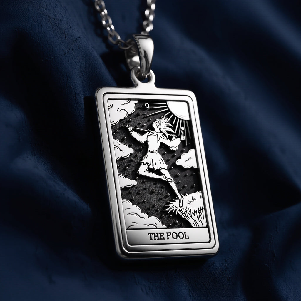 Rectangular 925 sterling silver pendant necklace featuring The Fool Major Arcana tarot card engraving with a figure walking toward the sun, clouds, and stars, labeled “THE FOOL” at the bottom.