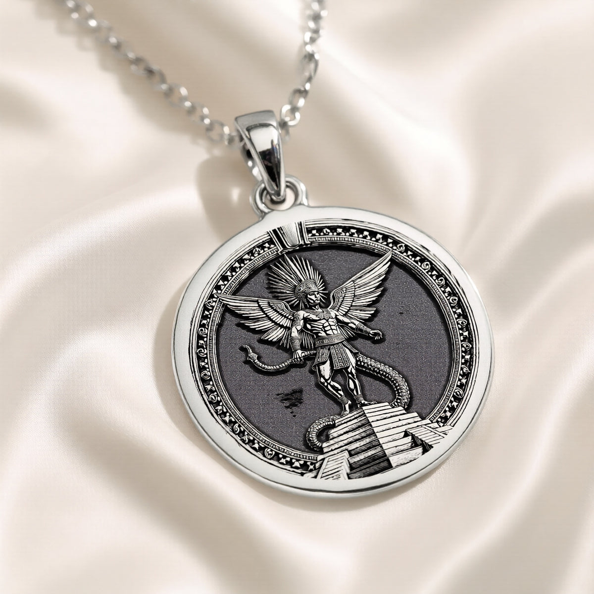 Silver pendant featuring a detailed design of an Aztec Sun God warrior, circular shape with intricate details, viewed from the front on a delicate chain