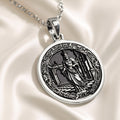 Silver pendant featuring a circular design of a king chess motif with intricate details, presented on a dark background