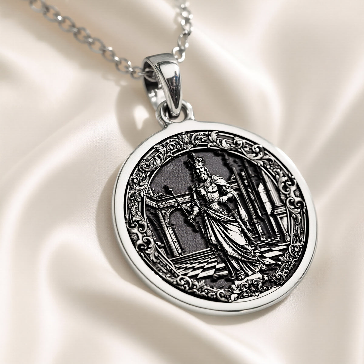 Silver pendant featuring a circular design of a king chess motif with intricate details, presented on a dark background