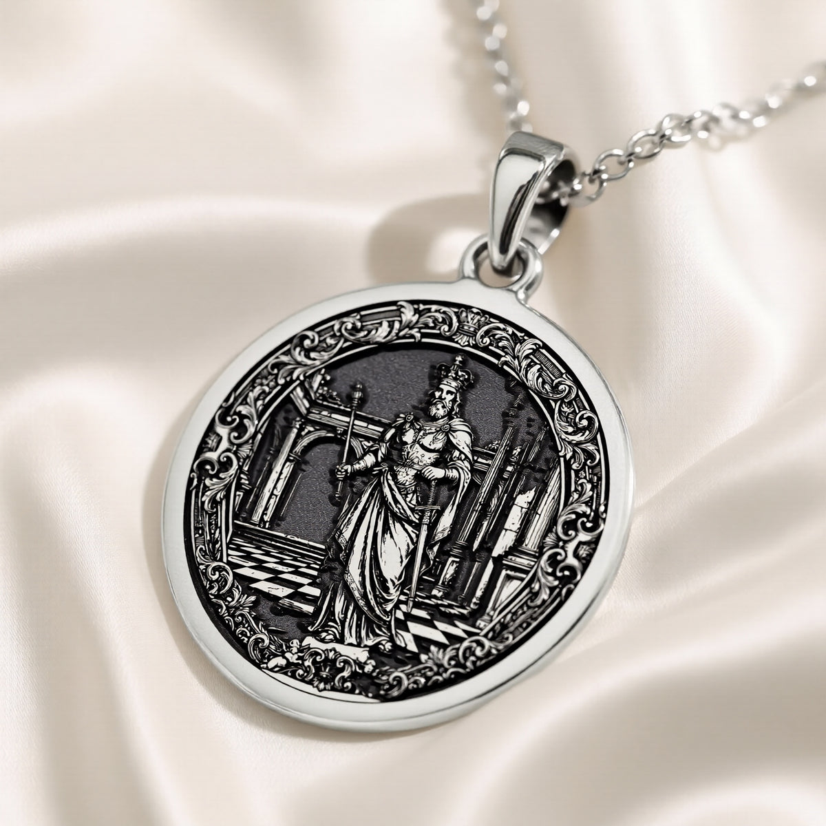 Silver pendant featuring a circular design of a king chess motif with detailed engraving, shown from a close-up angle on a velvet surface with a silver chain visible