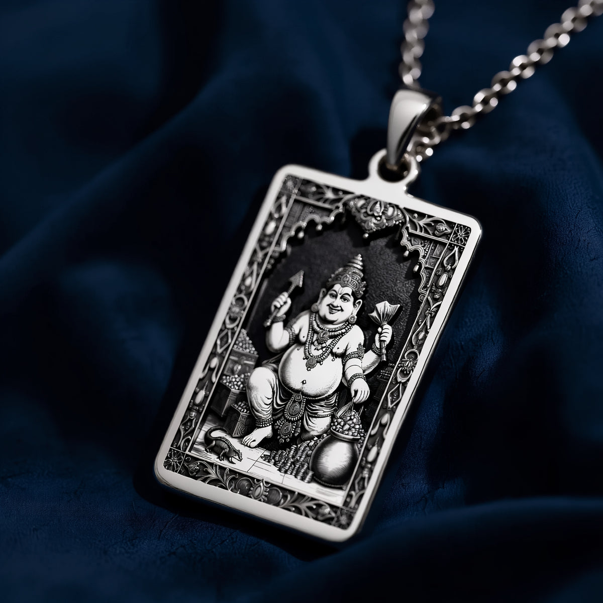 Silver pendant featuring a detailed depiction of Kubera God of Wealth in a traditional style. The pendant has a polished surface finish and is shown from a slight angle.