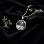 Lilith Rebel Goddess Coin Pendant Necklaces 925 925 Sterling Silver round pendant with winged figure design on a chain.