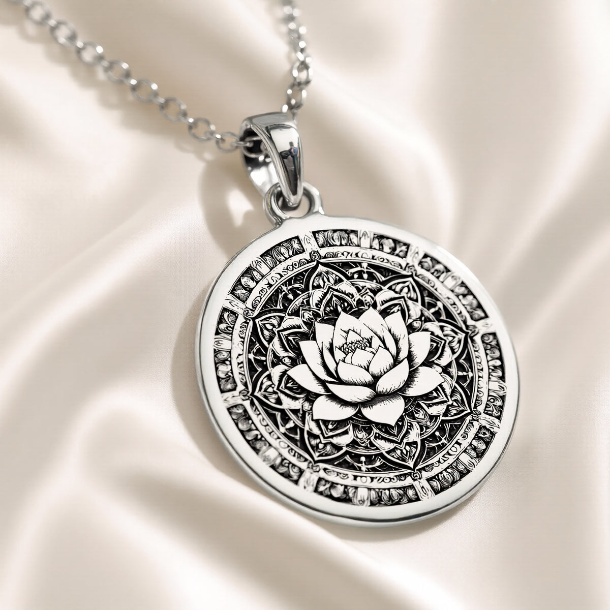 Silver pendant featuring an intricate lotus mandala design with detailed circular patterns. The pendant has a polished surface finish and is suspended from a delicate silver chain
