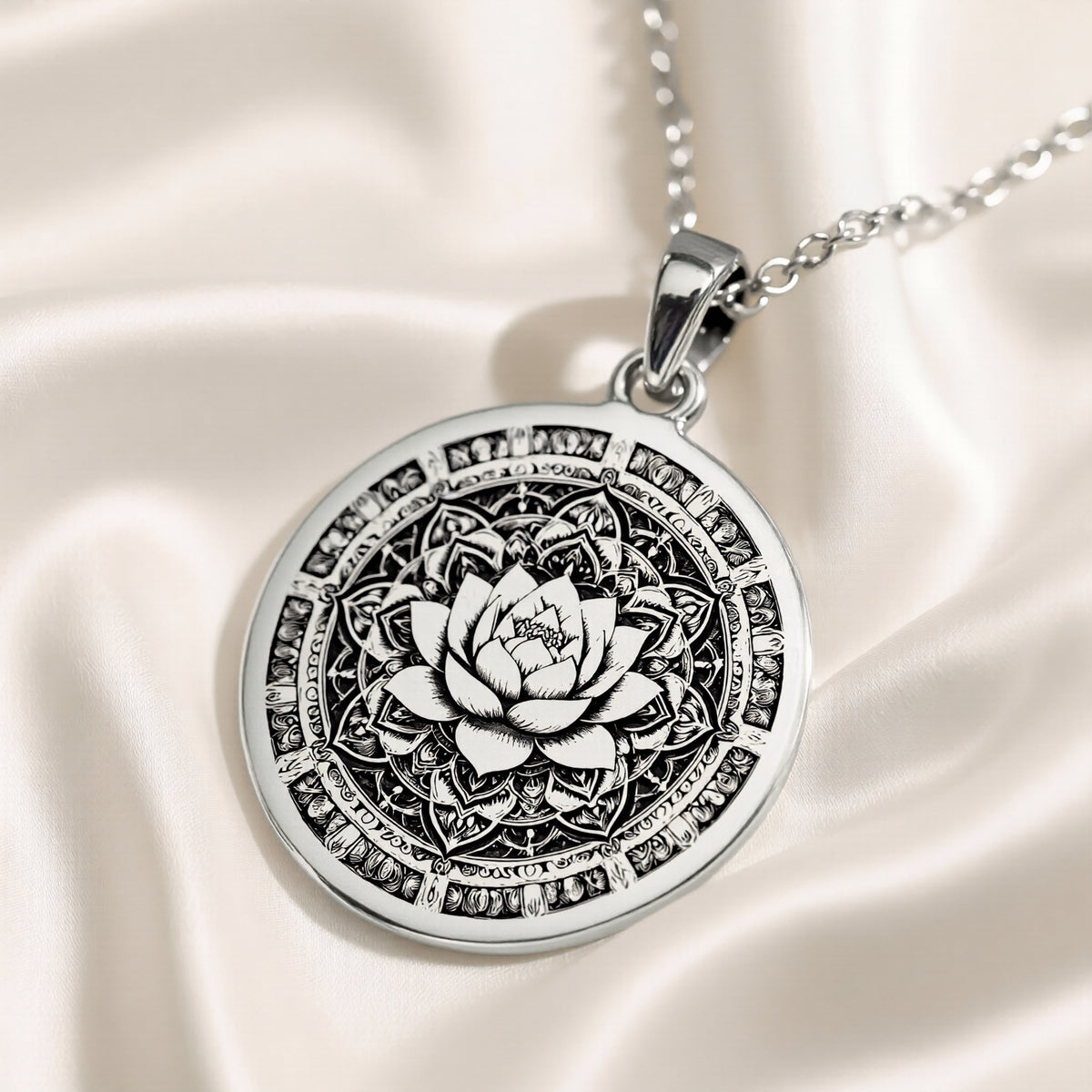 Silver pendant featuring a detailed lotus mandala design with intricate geometric patterns. The pendant has a textured surface finish and is displayed on a dark background with soft lighting