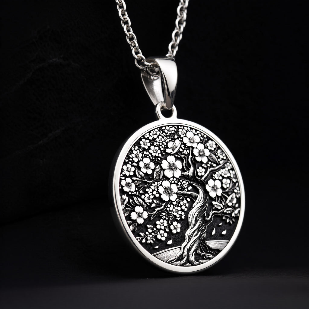 Sakura Tree Pendant in sterling silver showing front view of engraved cherry blossom tree design on round medallion.