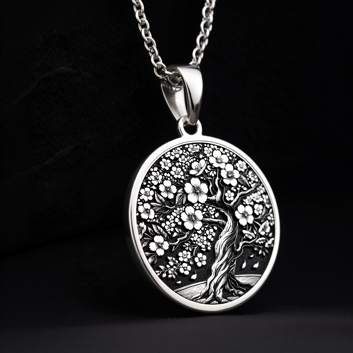 Sakura Tree Pendant in sterling silver showing front view of engraved cherry blossom tree design on round medallion.