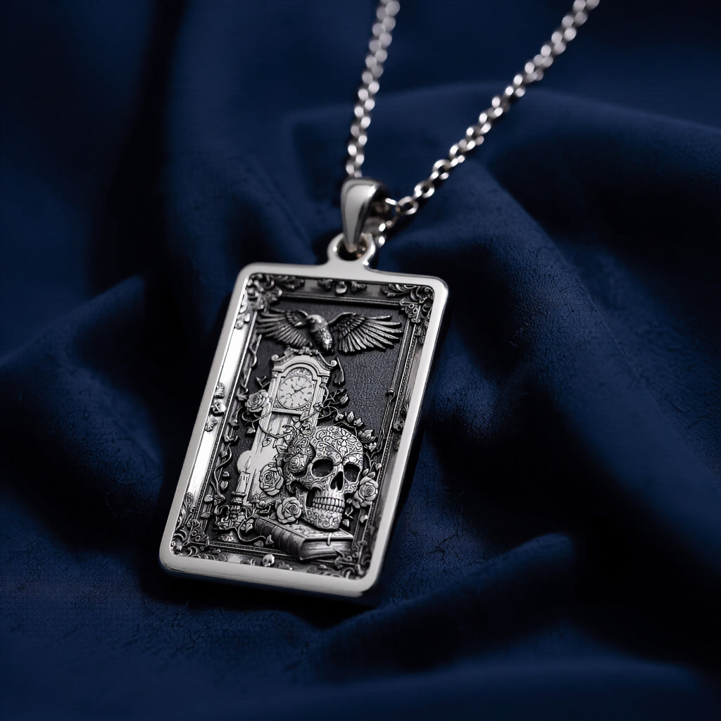 Silver skull tarot pendant with gothic style design, polished surface finish, viewed from a slight angle. The pendant is attached to a delicate chain, showcasing intricate details suitable for a memento mori aesthetic.