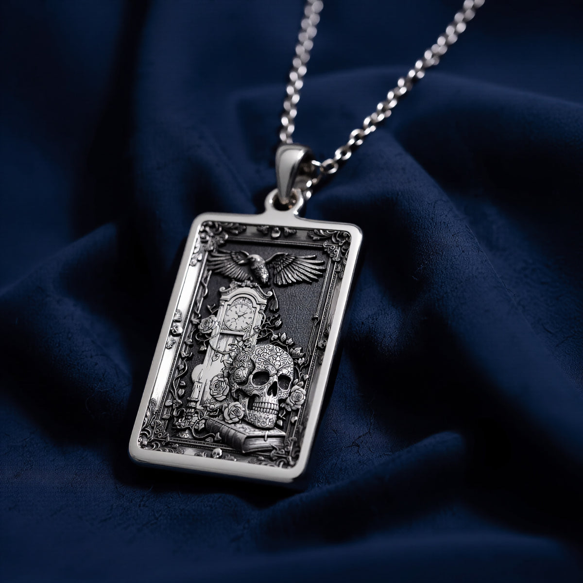 Silver skull tarot pendant with gothic style design, polished surface finish, viewed from a slight angle. The pendant is attached to a delicate chain, showcasing intricate details suitable for a memento mori aesthetic.