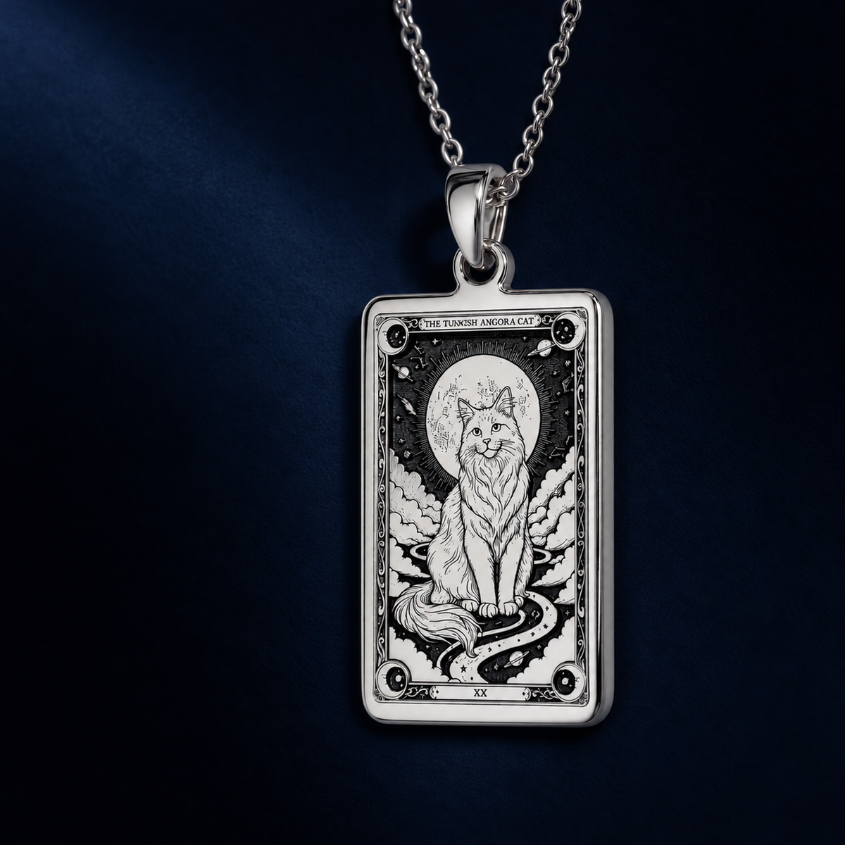 A vertical view of the sterling silver Turkish Angora cat tarot pendant against a deep navy background.